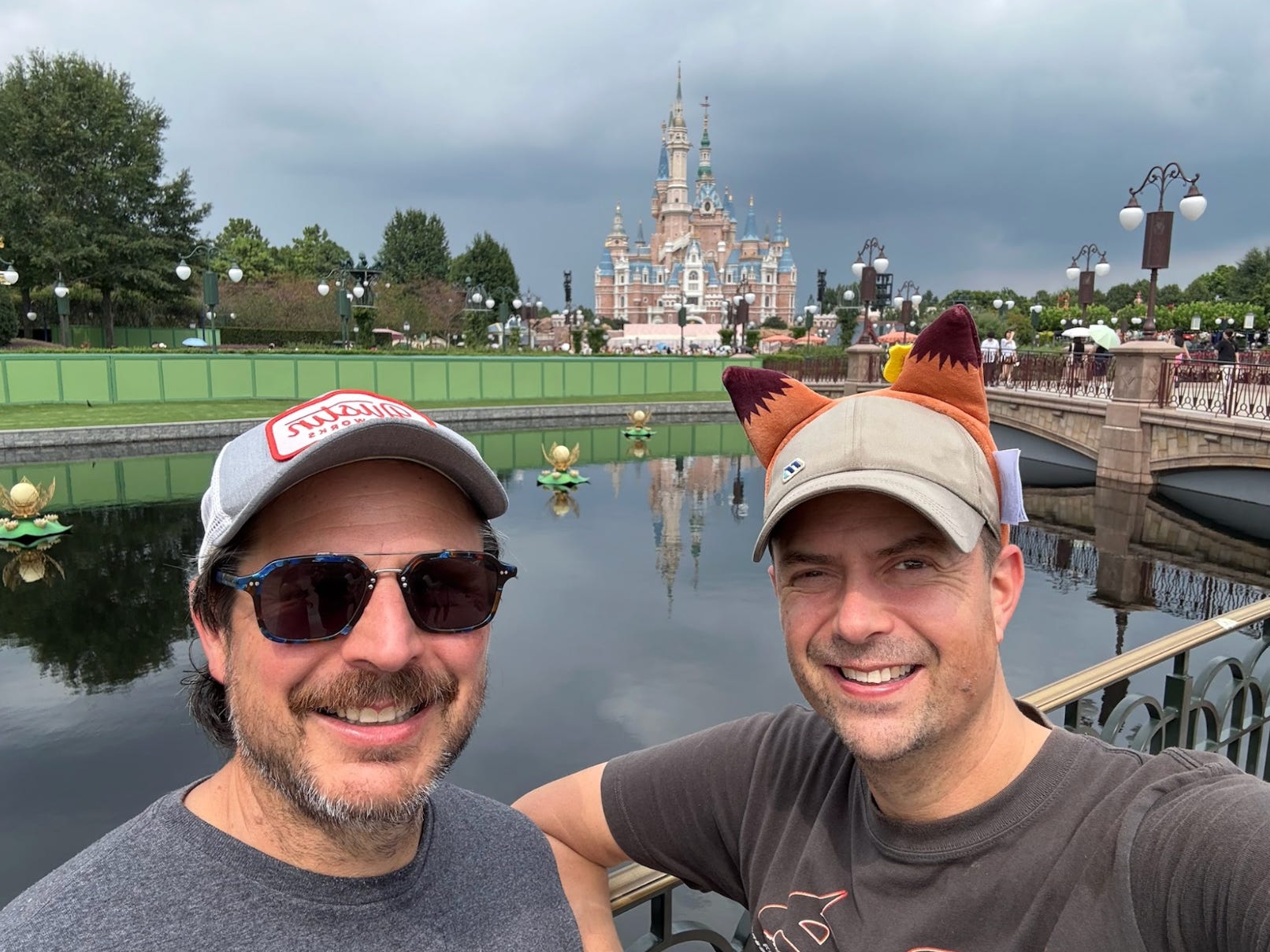 The writer and his best friend standing in front of a castle at Disney Shanghai.