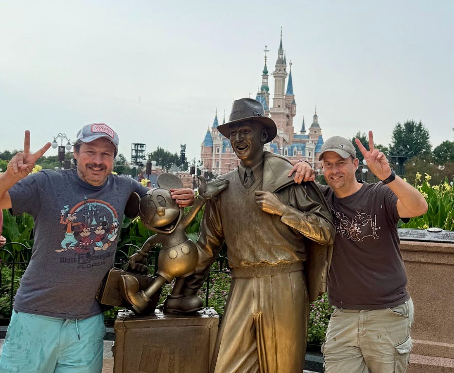 The writer and his best friend posing with a statue at Disneyland.