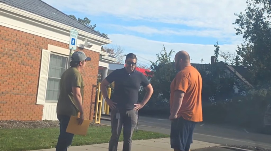 Mark Verity, an Islip resident and Wading River Elementary music teacher, standing outside with two other men.