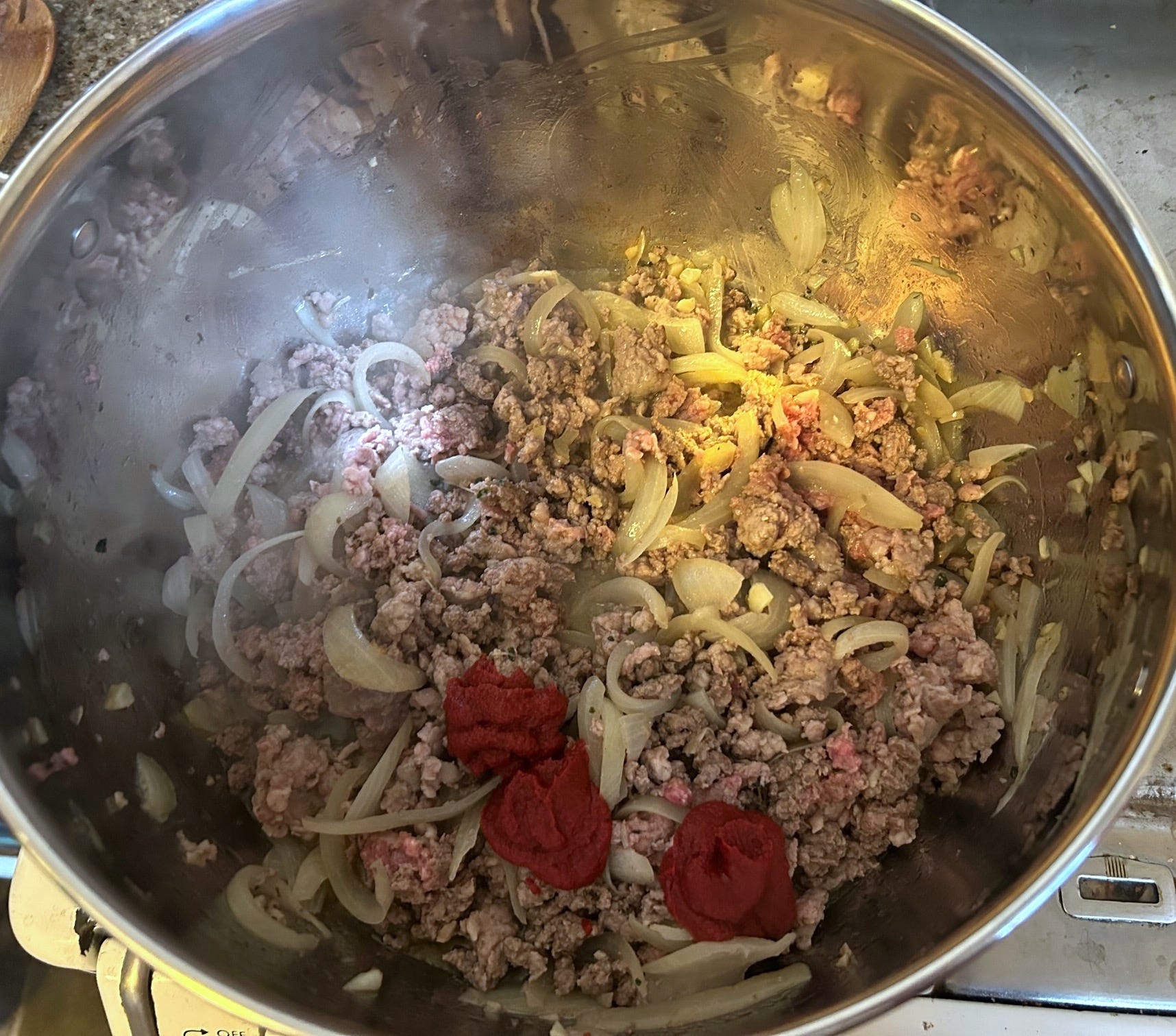 Adding tomato paste to meat for Pioneer Woman's Lasagna Soup