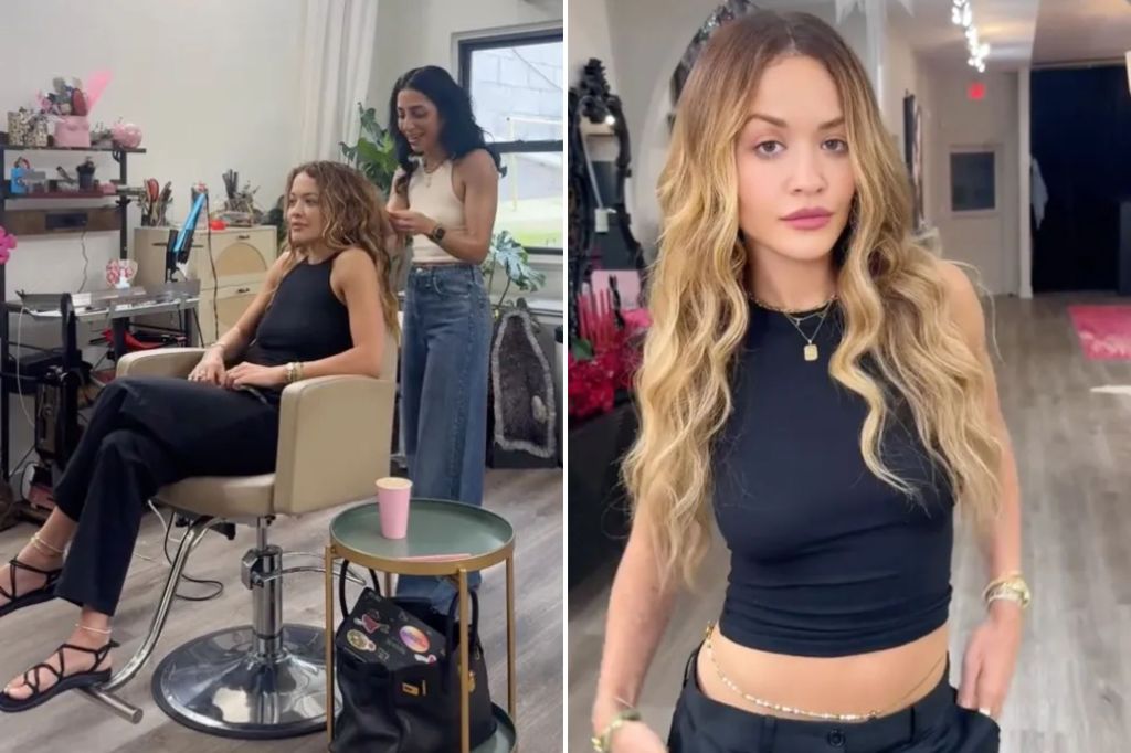 An image collage containing 2 images, Image 1 shows Rita Ora in a black halter top and pants, seated in a salon chair, looking left, while a stylist with dark curly hair works on her hair, Image 2 shows Rita Ora posing in a black crop top and black pants with a beaded waist chain