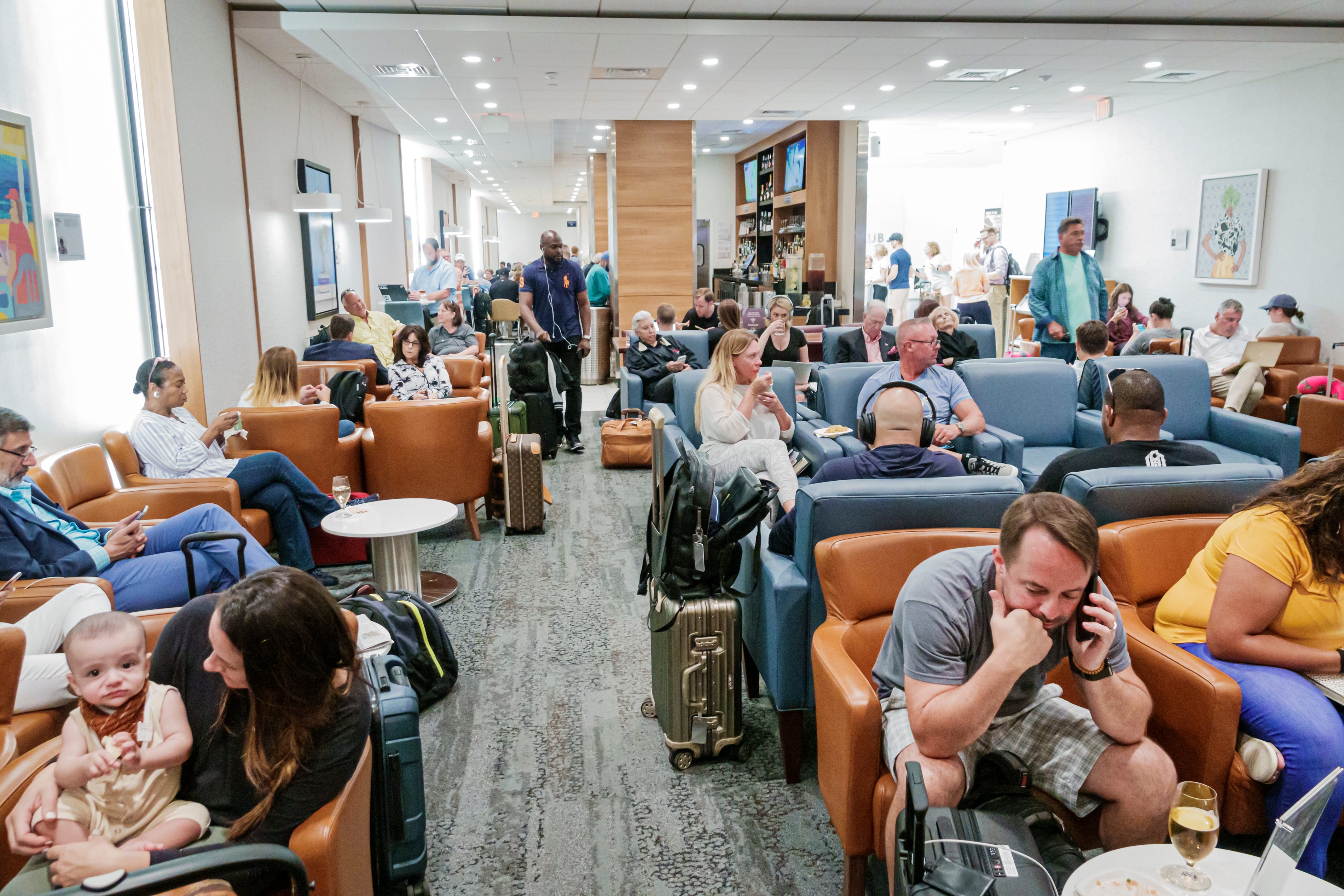 Delta skyclub lounge with a crowd of people.