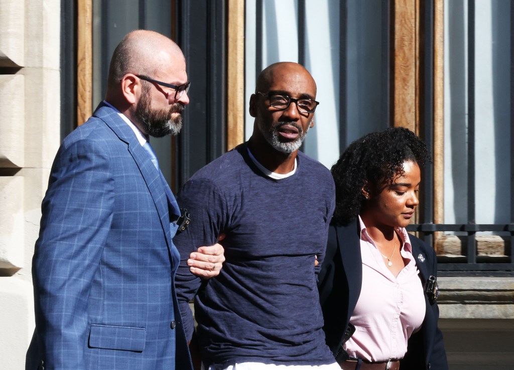 Michael Benjamin, 57, being escorted by officers at the Special Victims Unit at 1086 Simpson Street in the Bronx, NY.