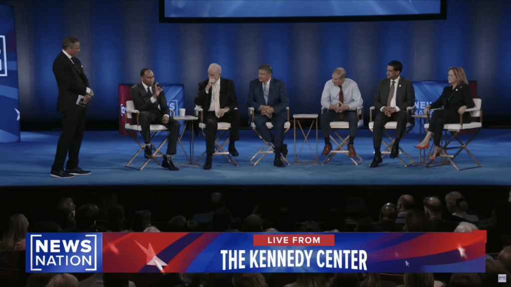 Stephen A. Smith and politicians on stage at a NewsNation town hall event.