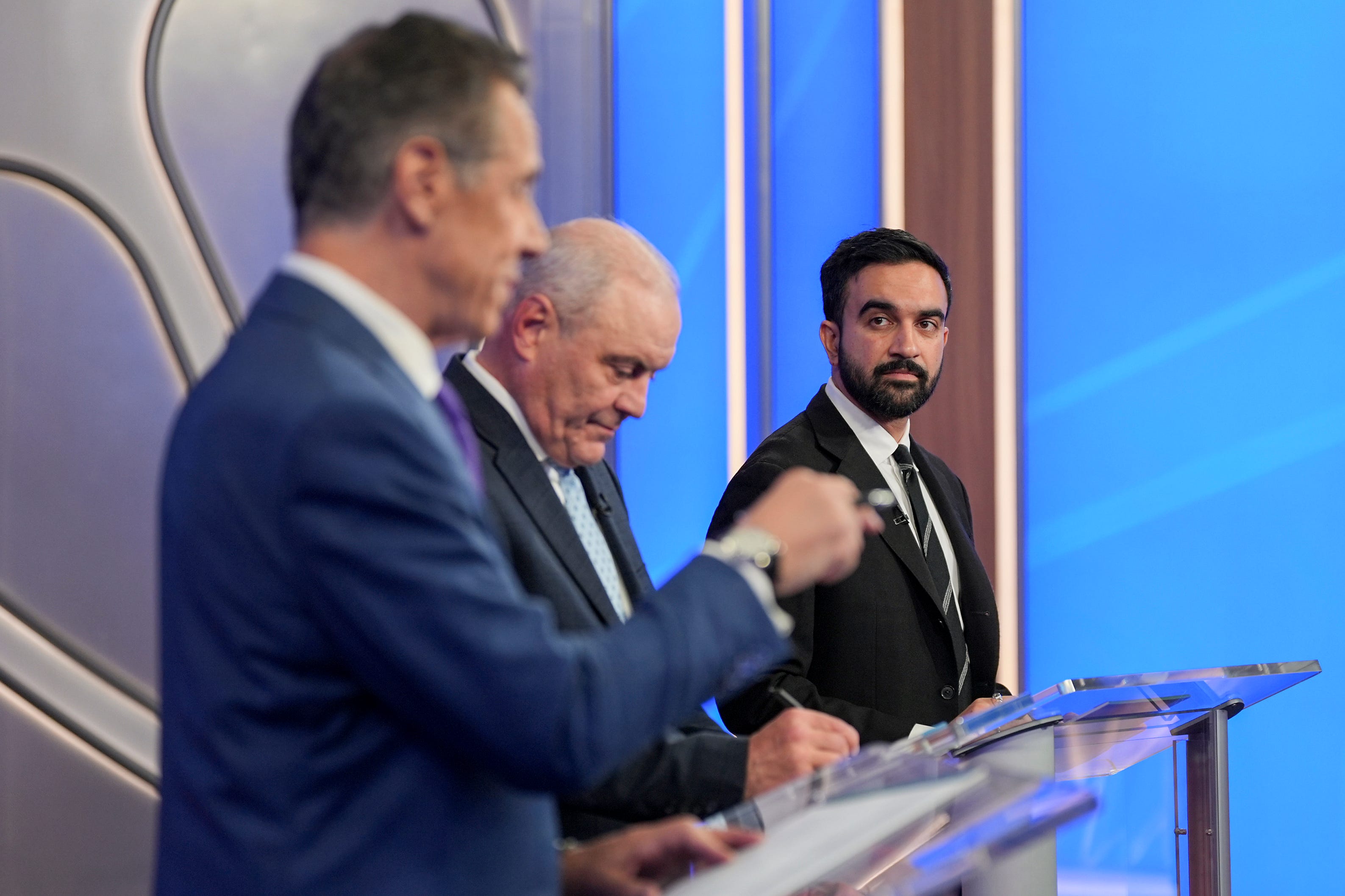 Cuomo, Sliwa, and Mamdani at the debate behind their podiums.