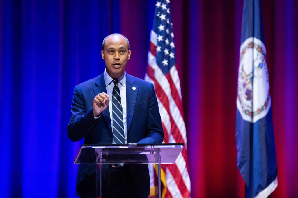 Democrat Jay Jones speaks at a podium during the Virginia attorney general debate.