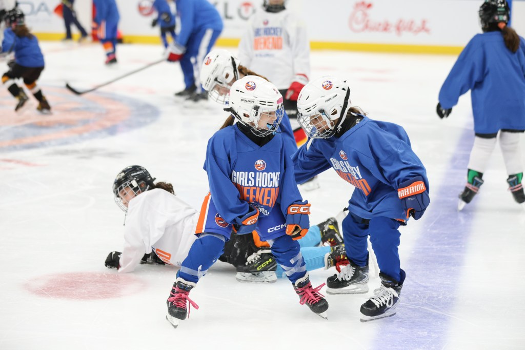 Girl hockey players participate in drills during a hockey clinic hosted by the Islanders at UBS Arena.
