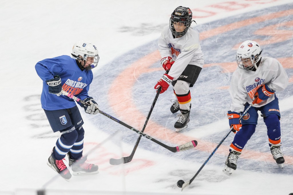 Girl hockey players participate in drills during a hockey clinic hosted by the Islanders at UBS Arena.