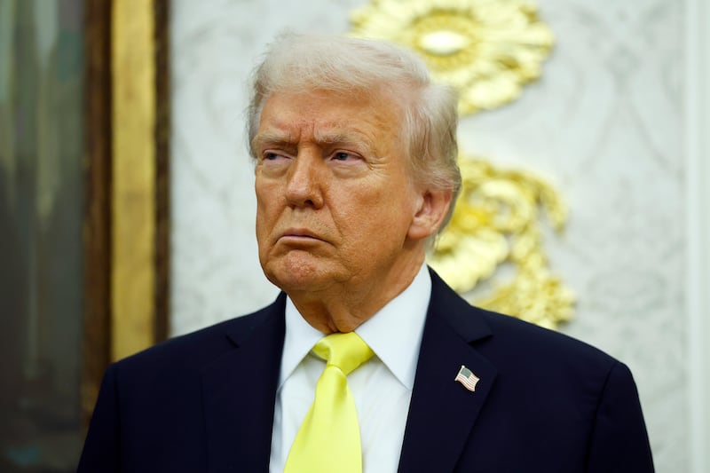 President Donald Trump looks on during a press conference in the Oval Office of the White House