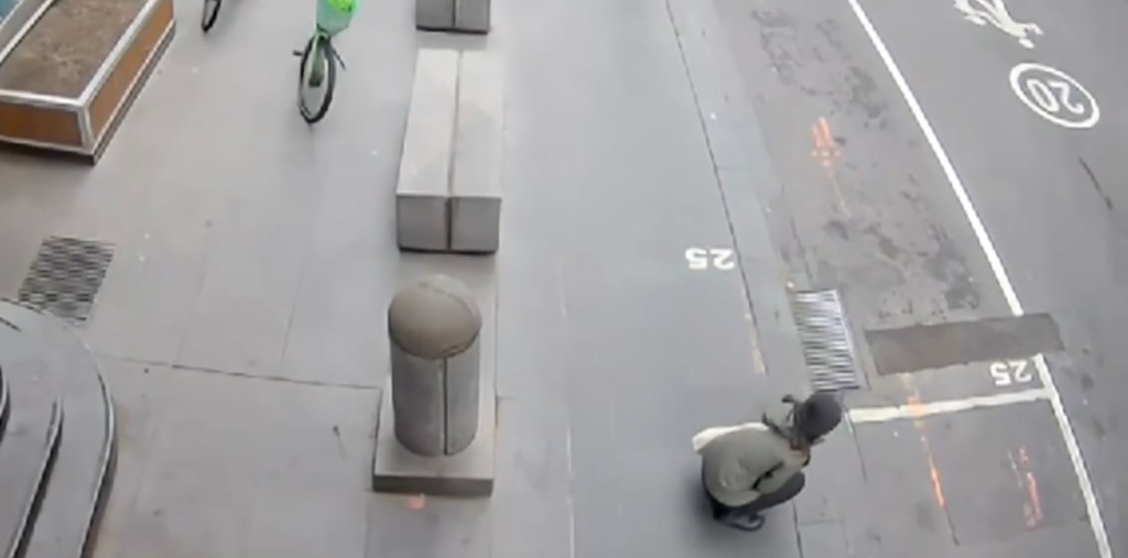 Lai clutched her wound and sat on the ground before a bystander ran over to help.