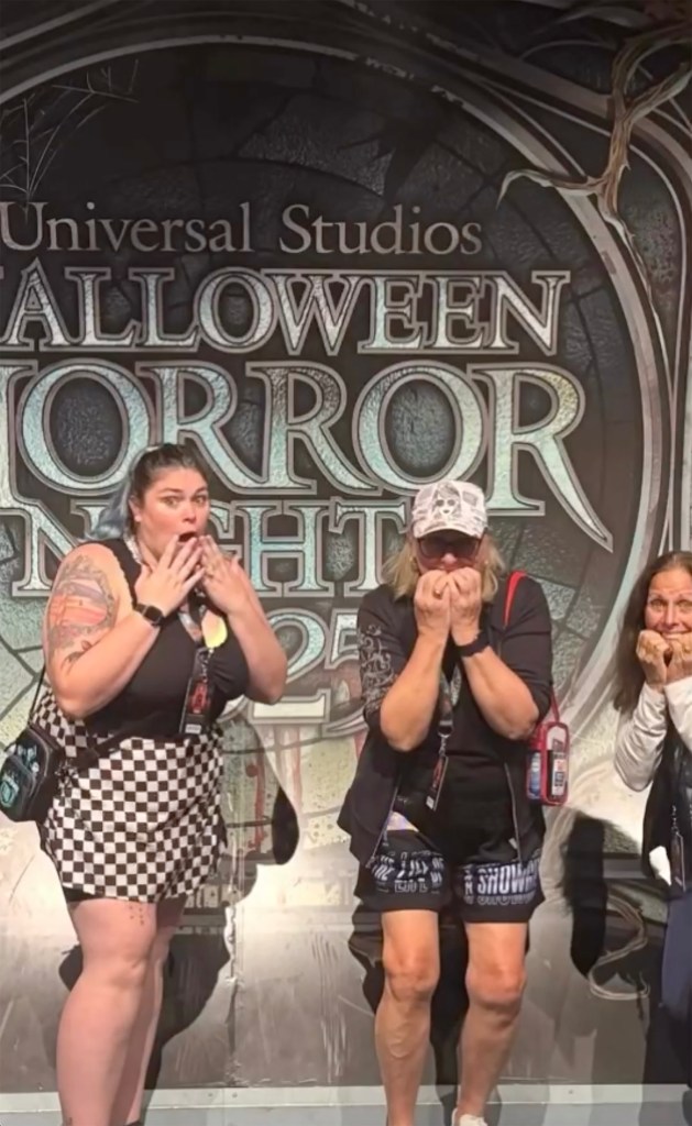 Donna Kelce with two other women at Halloween Horror Nights with their hands over their mouths in shock.