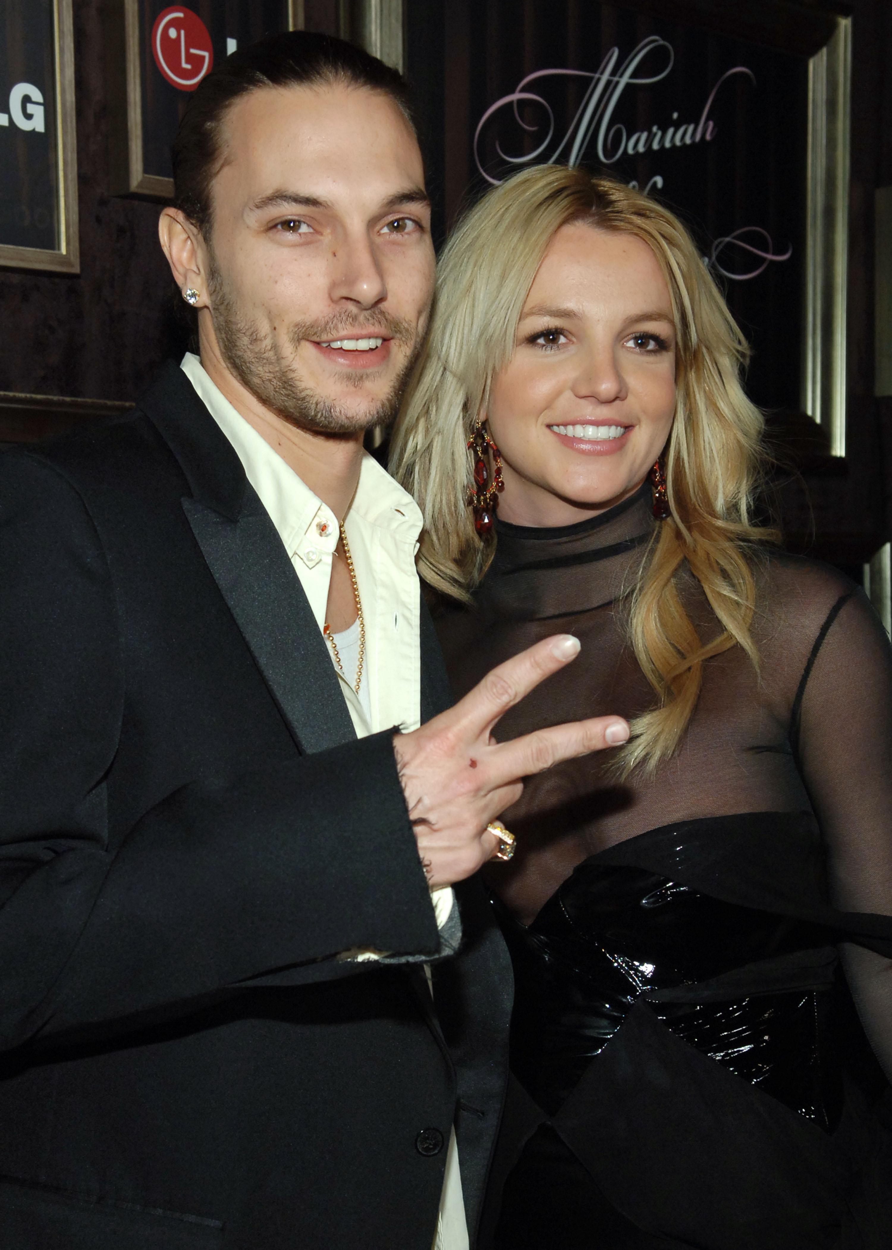 Kevin Federline and Britney Spears smiling at the camera.