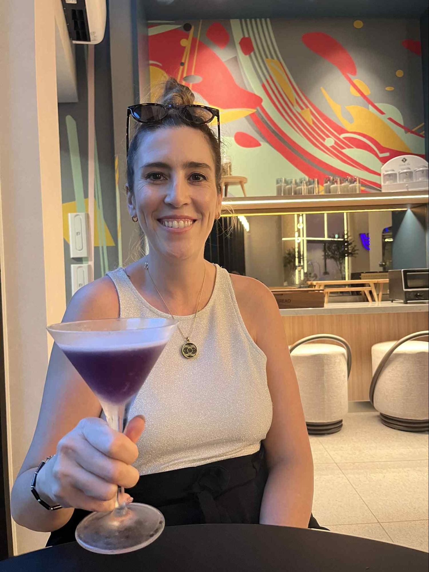 Michelle Gross smiling while holding a cocktail