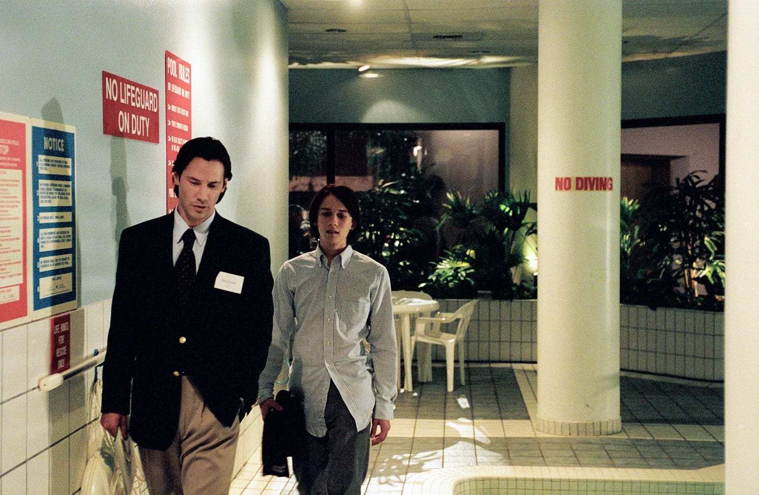 Keanu Reeves walking in a hallway in the movie Thumbsucker