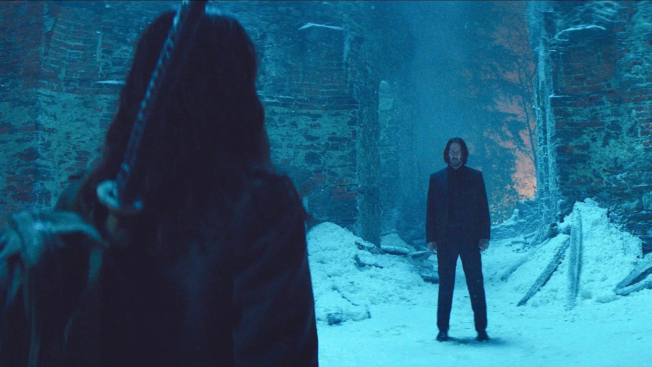 Keanu Reeves standing in the snow in the movie Ballerina