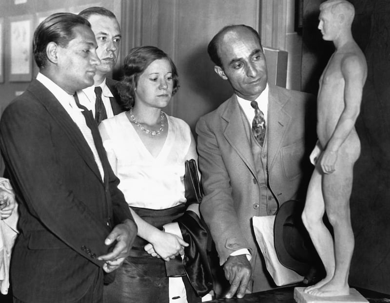 Visitors view the statue, which was created based on the measurements of approximately 100,000 American veterans, presented at a eugenics conference
