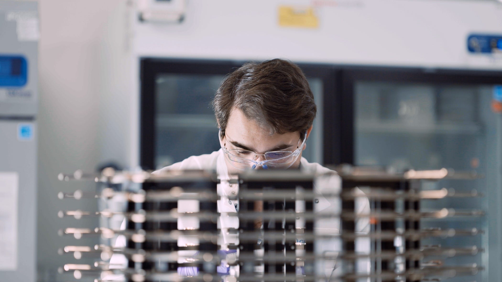 guardant employee in lab coat working