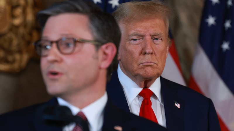Donald Trump listens as Speaker of the House Mike Johnson (R-LA) speaks during a press conference at Mr. Trump's Mar-a-Lago estate on April 12, 2024, in Palm Beach, Florida.