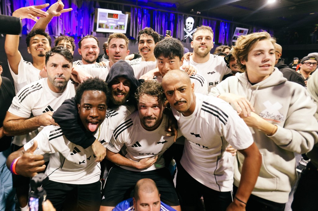 Justin Bieber with a group of men in white jerseys and black shorts at the Skylrk x Loyal Link soccer game.