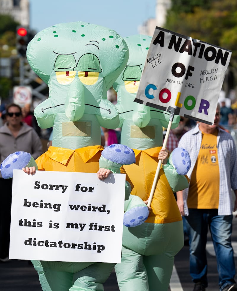 Protesters march down Pennsylvania Avenue NW for the second "No Kings" protest in Washington on Saturday, October 18, 2025.
