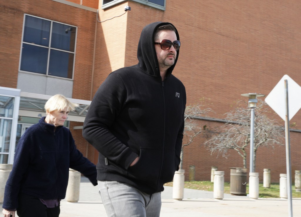 Mark Verity walking out from the First District Court in Suffolk County with his parents after being arraigned Oct. 18, 2025