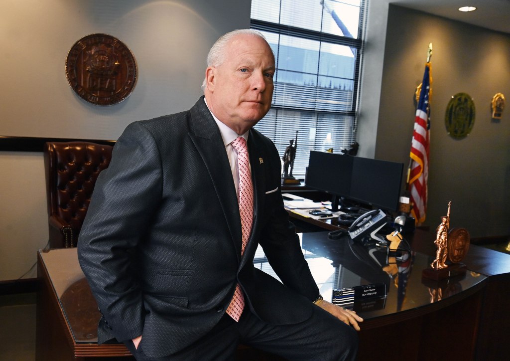 Detective Scott Munro, president of the Detectives' Endowment Association, sits in his office.