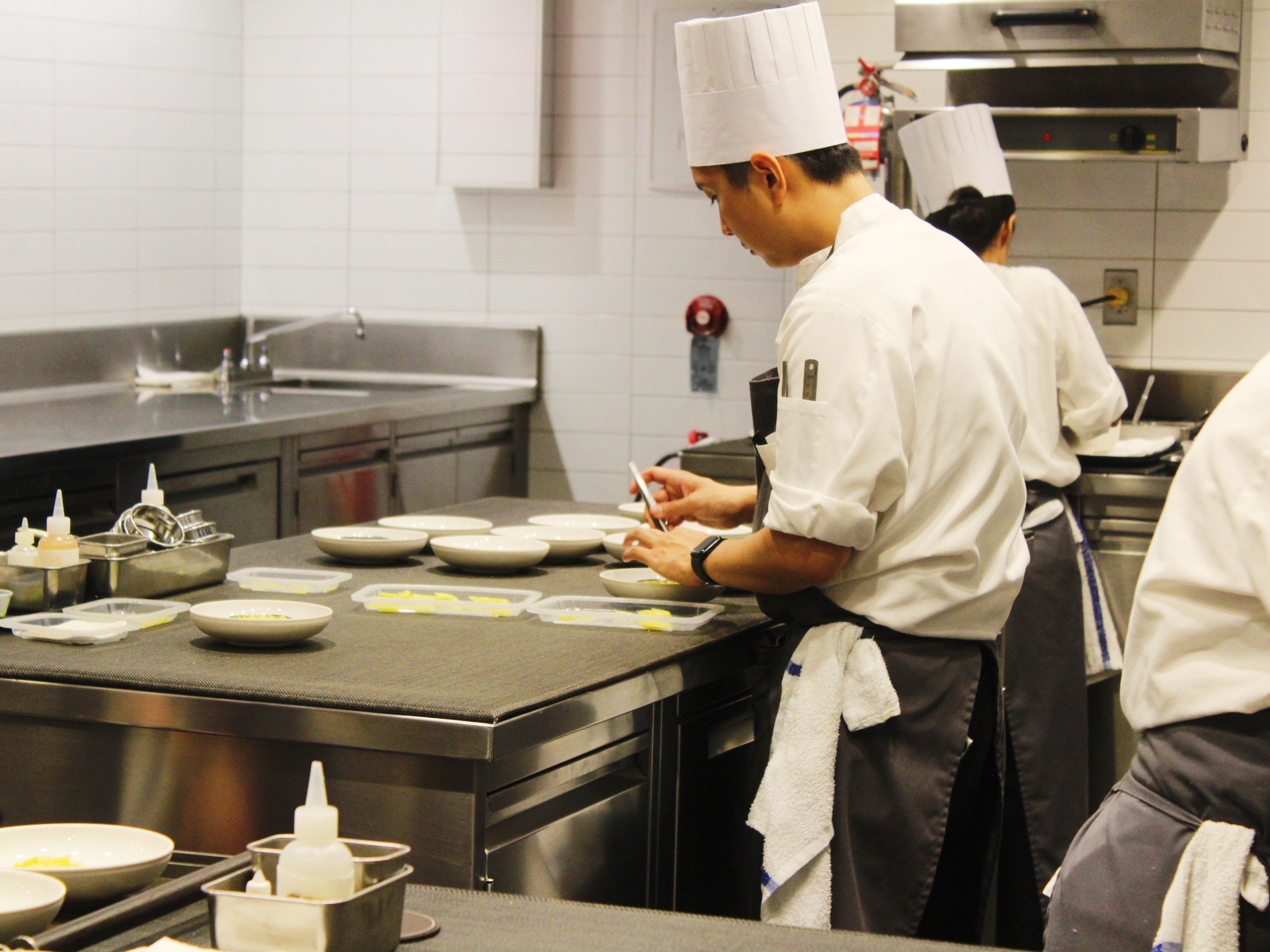 eleven madison park kitchen staff preparing food