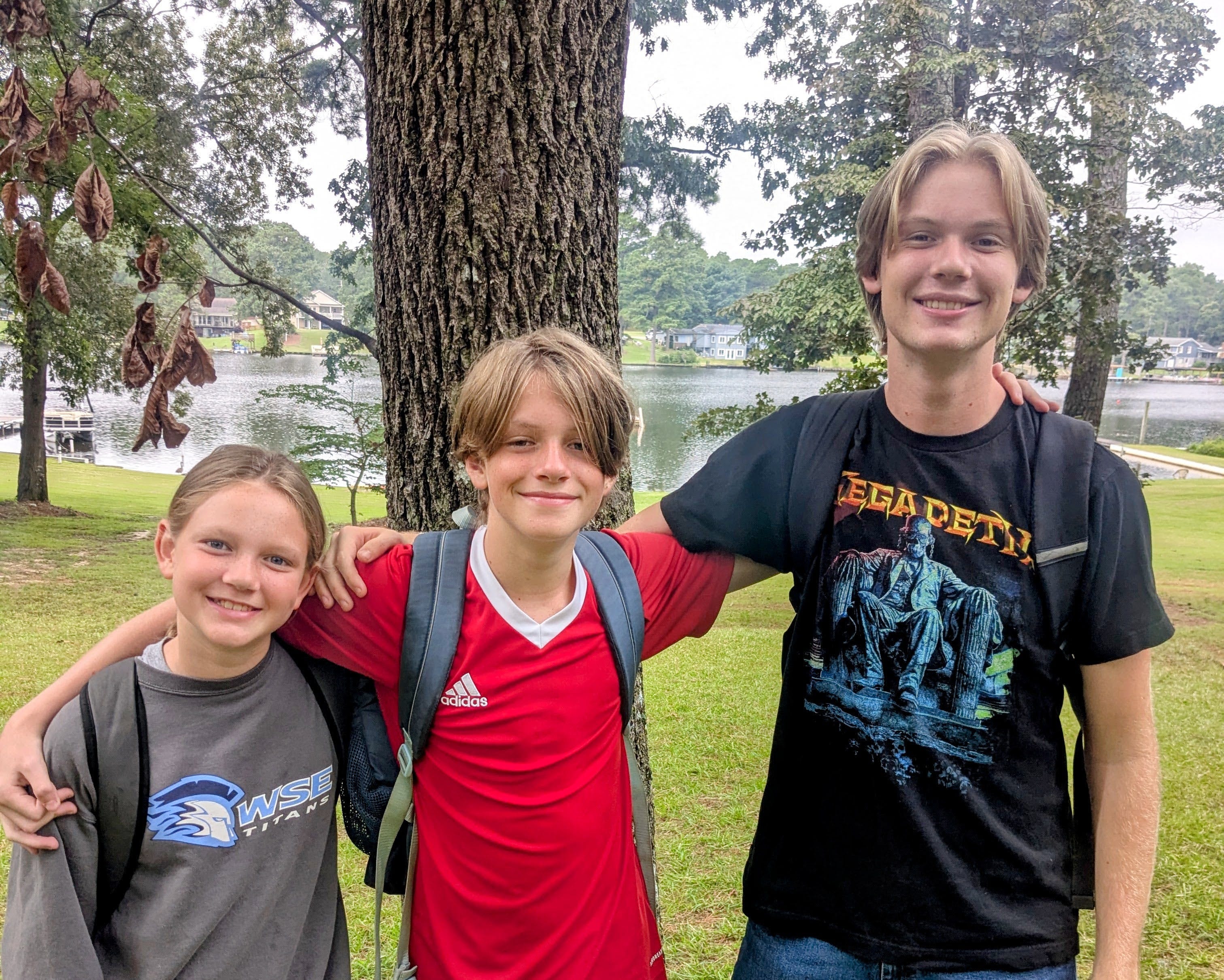The author's children pose outside of their home.