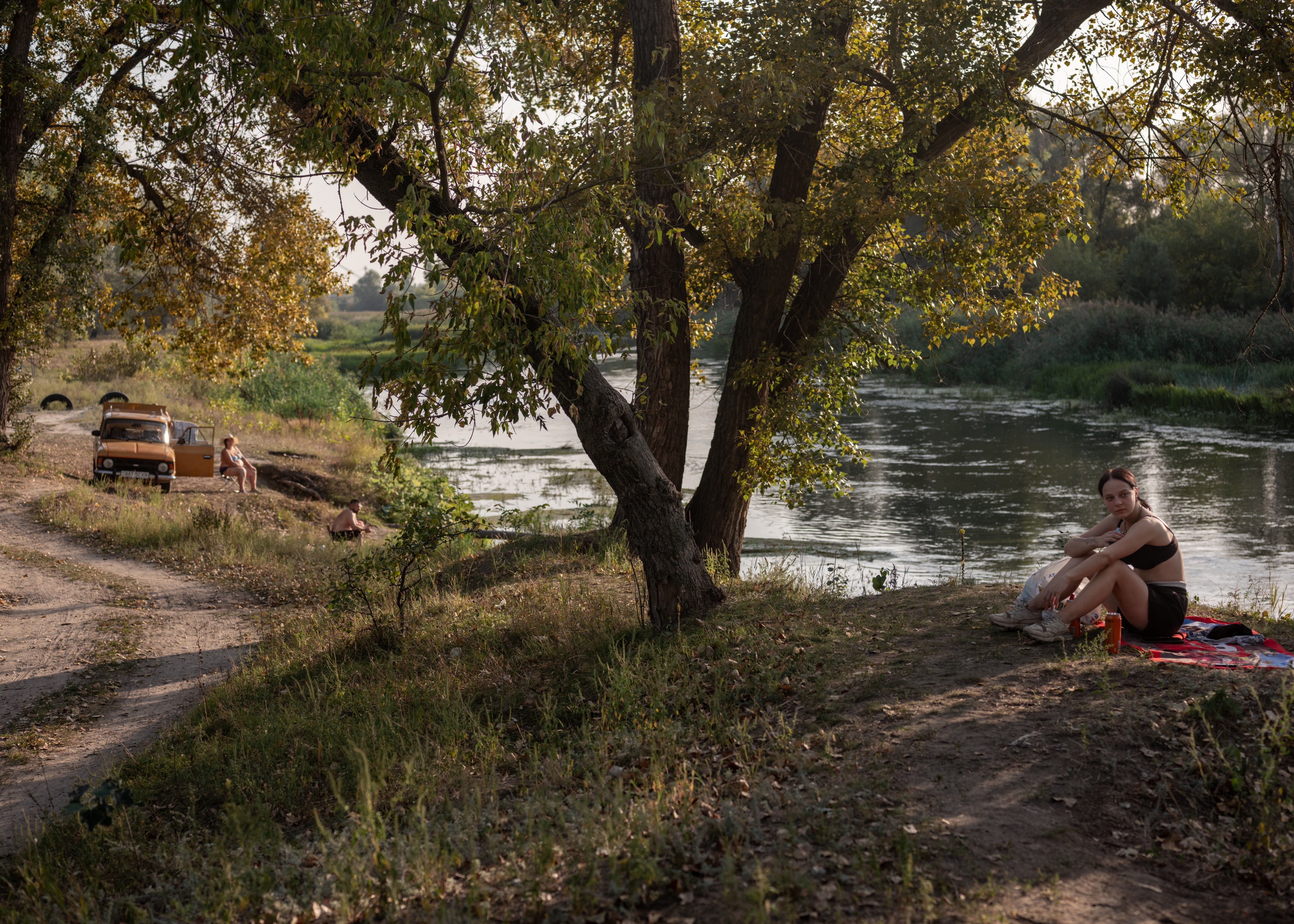 Picture of Diana, 17 sitting on the bank of Siverskyi Donets river in the town of Izium.