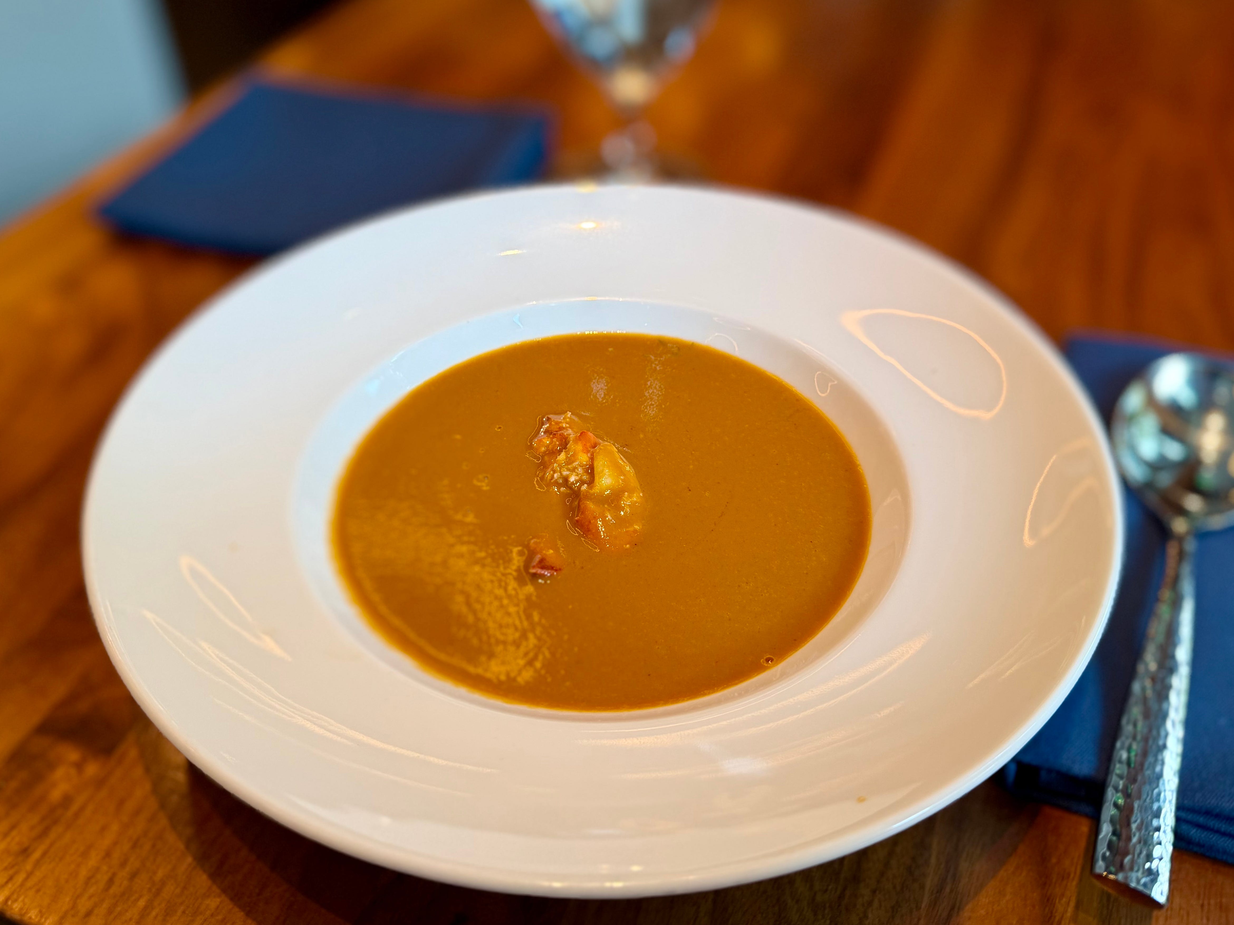 A bowl of lobster bisque on a table.