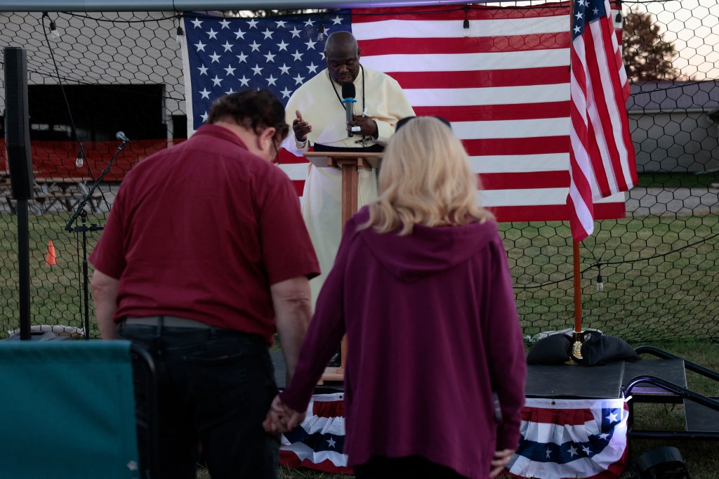 Pastor Fr. Georges Bidzogo leading a prayer vigil.