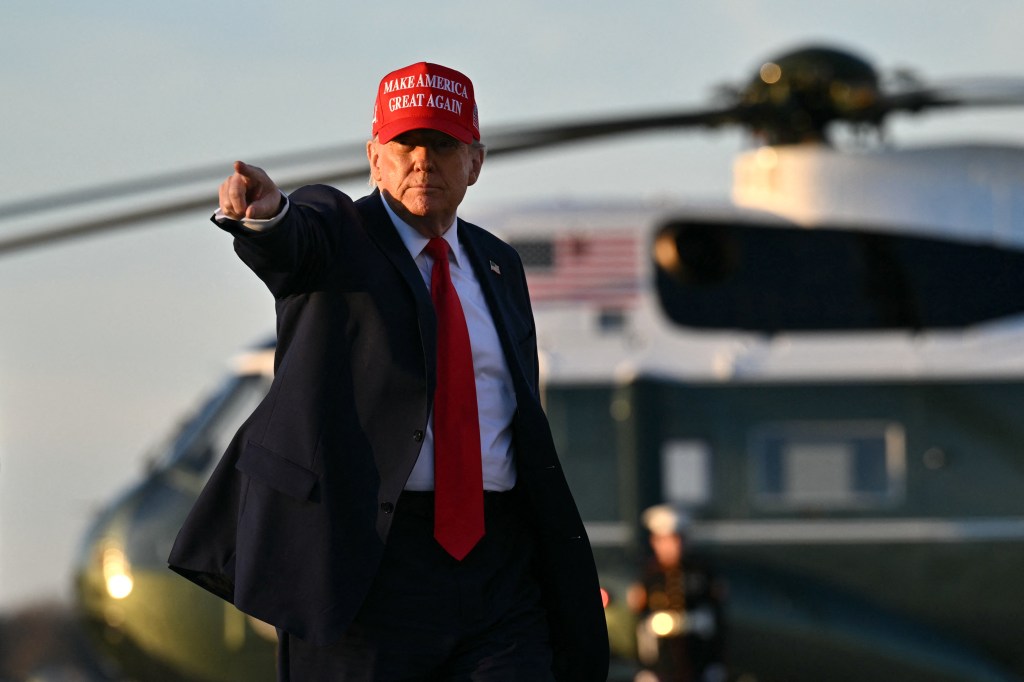 Donald Trump points while walking to board Air Force One at Joint Base Andrews.