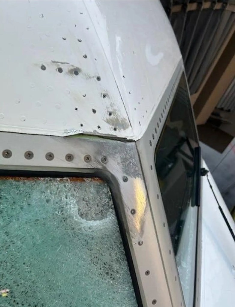 A scorched and cracked airplane windshield.