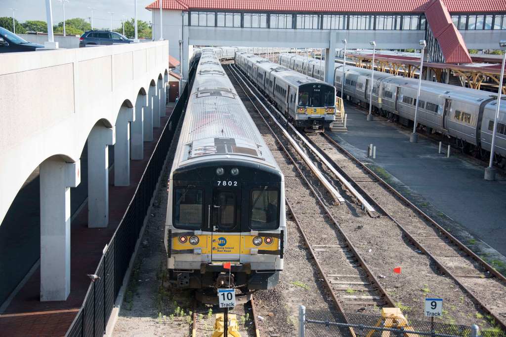 Two Long Island Rail Road trains are parked on tracks 9 and 10 at the Long Beach LIRR station.