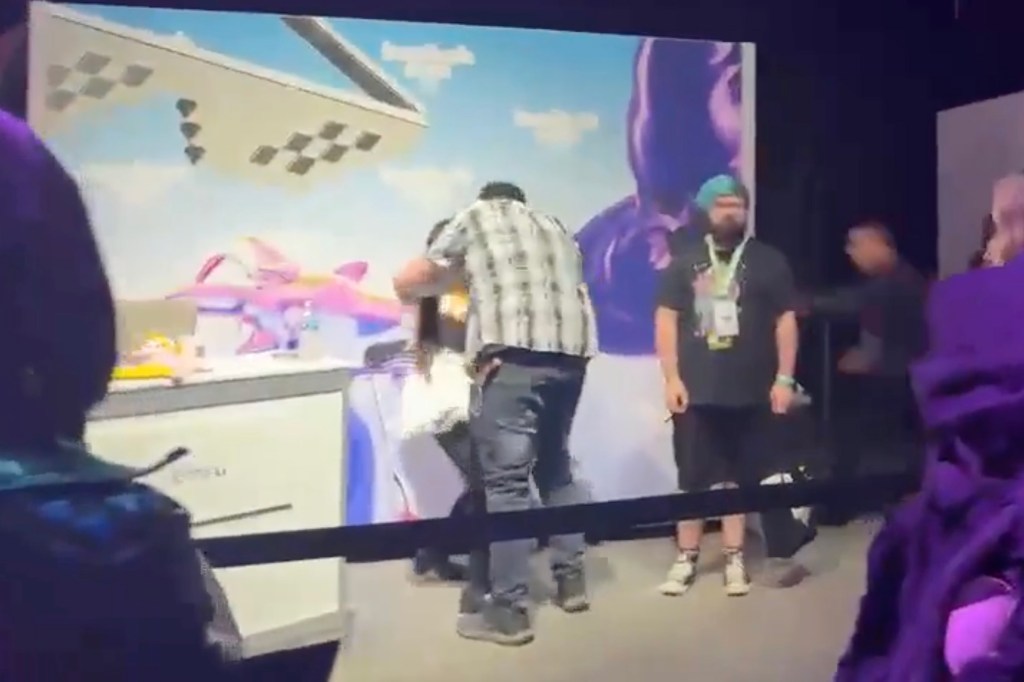A man in a plaid shirt lunges towards a woman at TwitchCon.