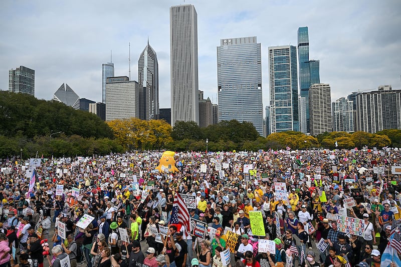 Demonstrators protest during the "No Kings" march at Grant Park on October 18, 2025 in Chicago, Illinois. Thousands of people attended the protest to speak out against President Donald Trump and his administration.