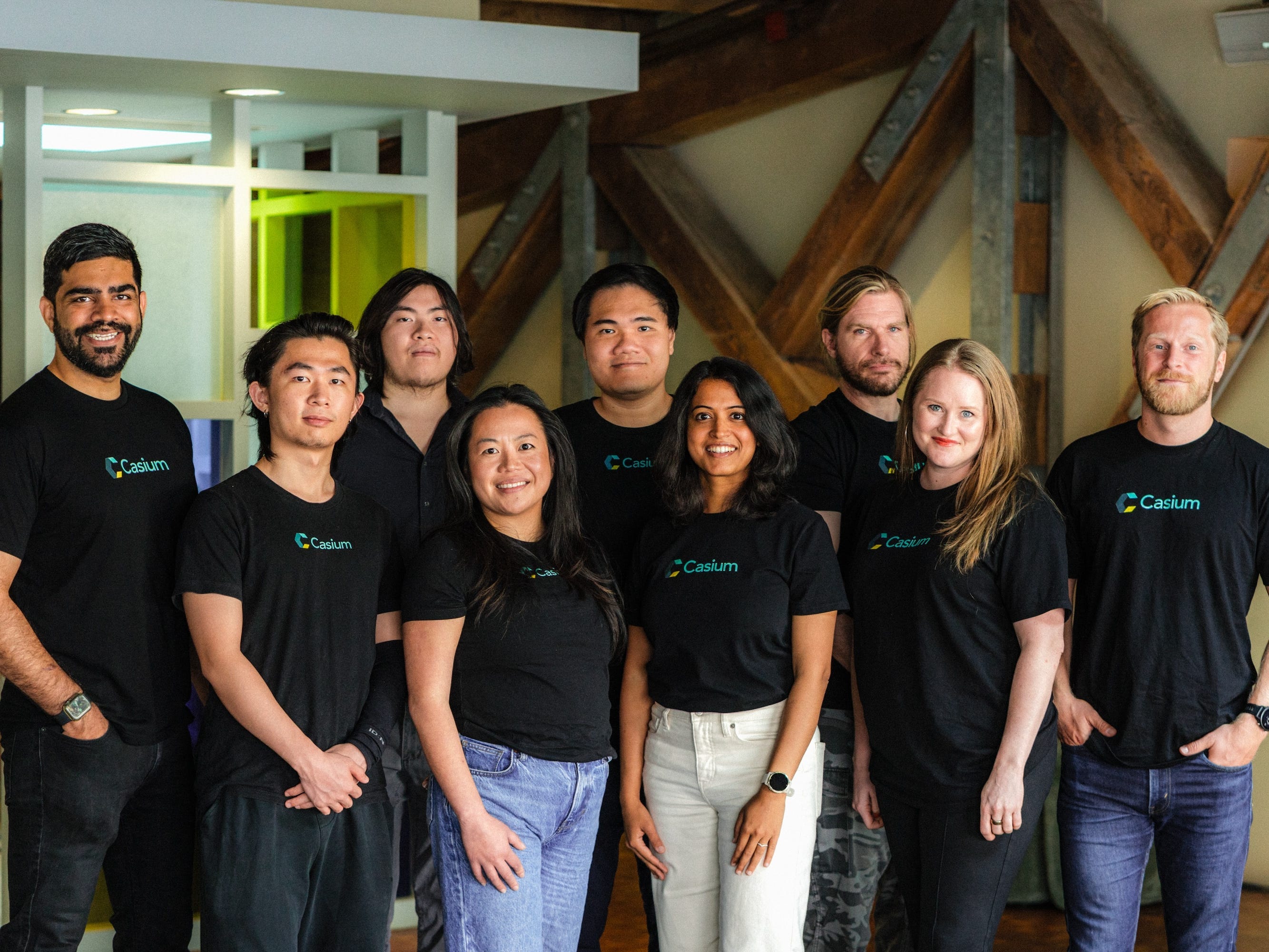 People in matching branded tees pose for a photo