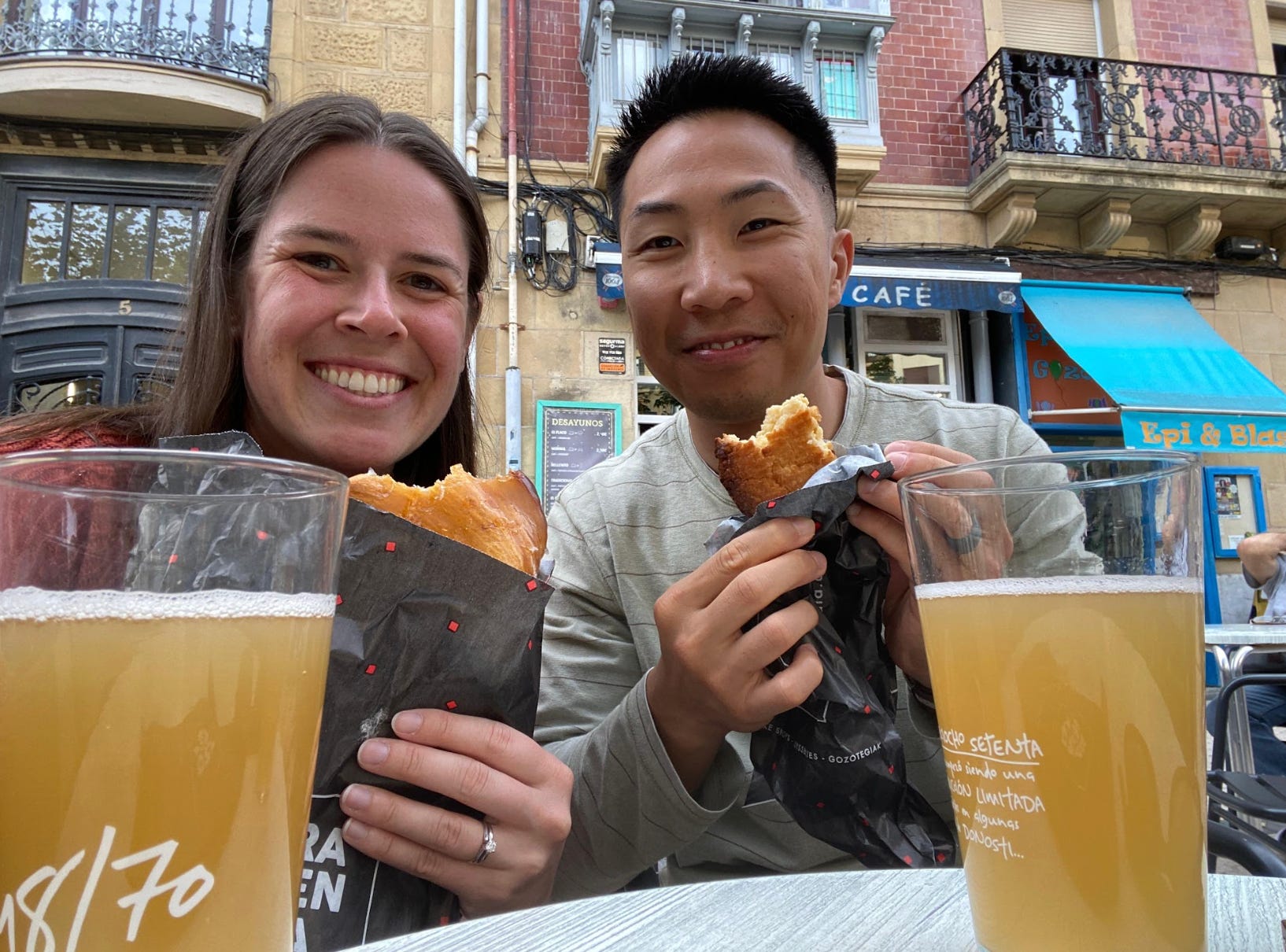 The writer and her husband eating and drinking beer on the street in San Sebastian, Spain.