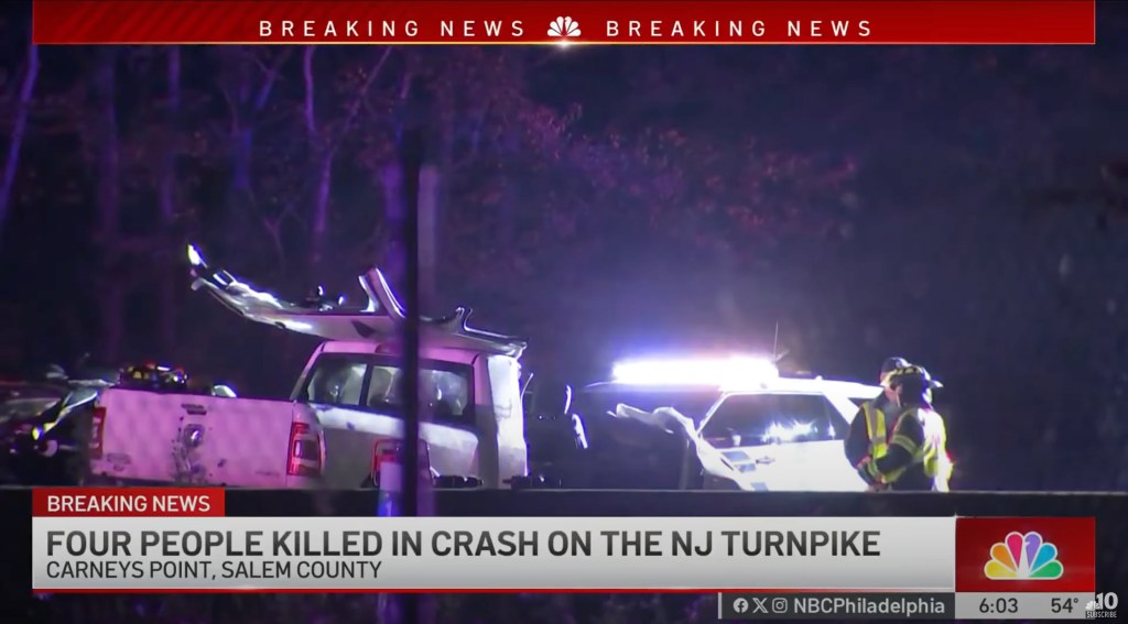 Police and emergency personnel at the scene of a fatal crash involving a pickup truck.