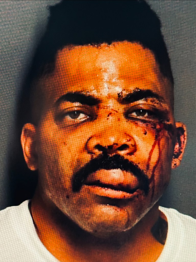 Mugshot of Daniel Christopher Hyden with cuts and blood on his face.