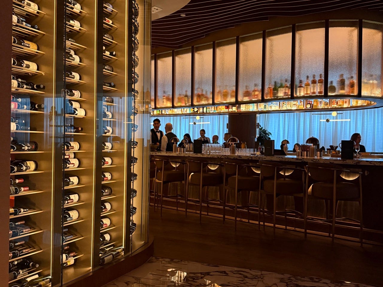 Interior of 1587 bar area with wine bottles in glass case