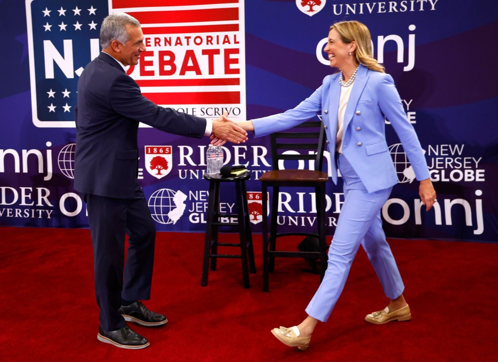 Republican Jack Ciattarelli and Democrat Mikie Sherrill shaking hands before a debate.