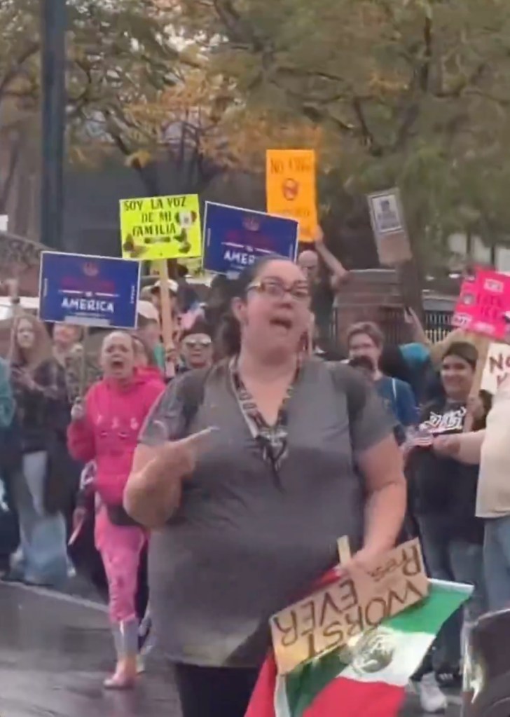 Lucy Martinez, a Chicago school teacher, shouting and holding a sign with a Mexican flag during a protest.