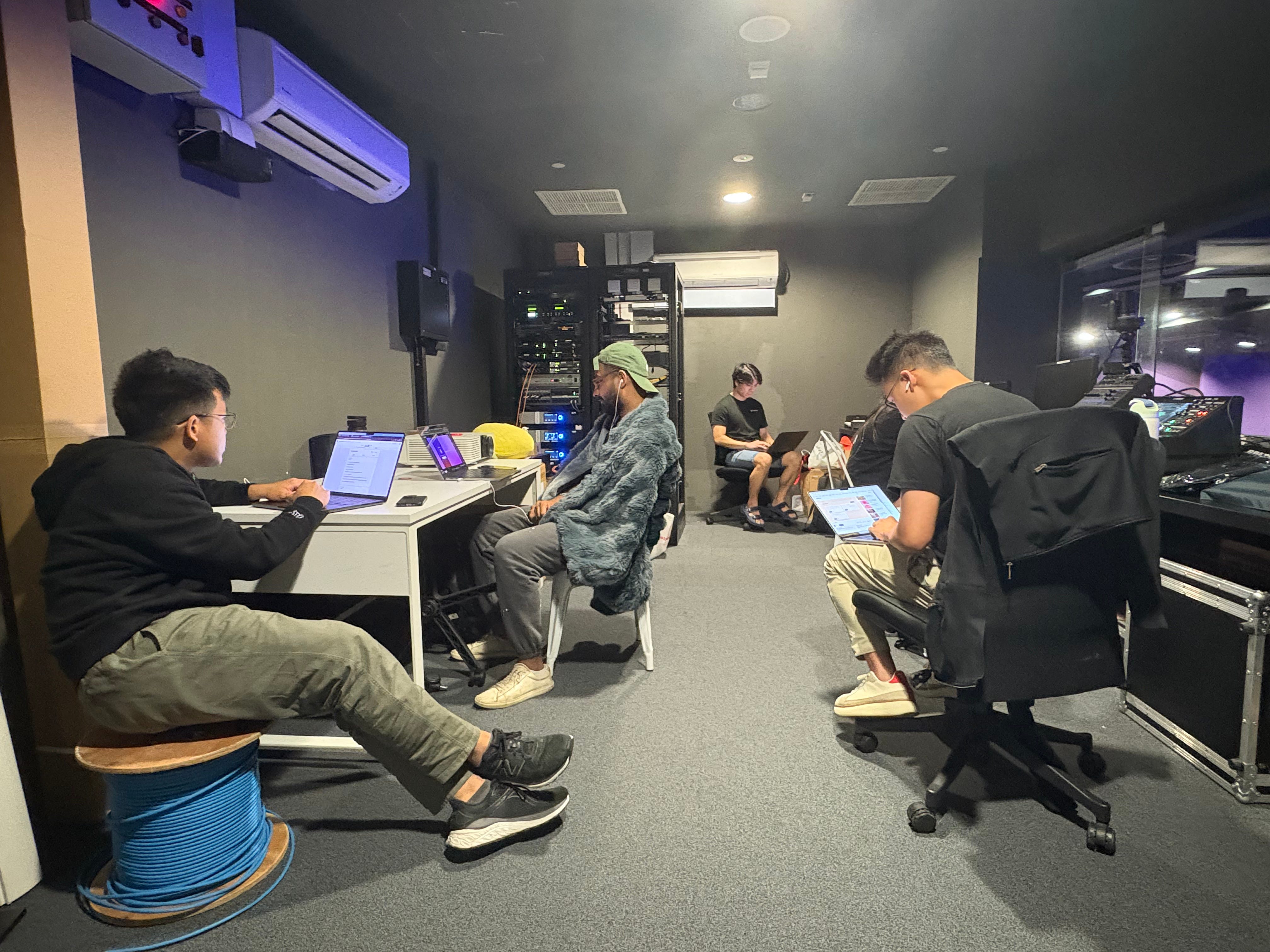 Five organizers speed watching demo videos in the audio visual room to shortlist the final participants.