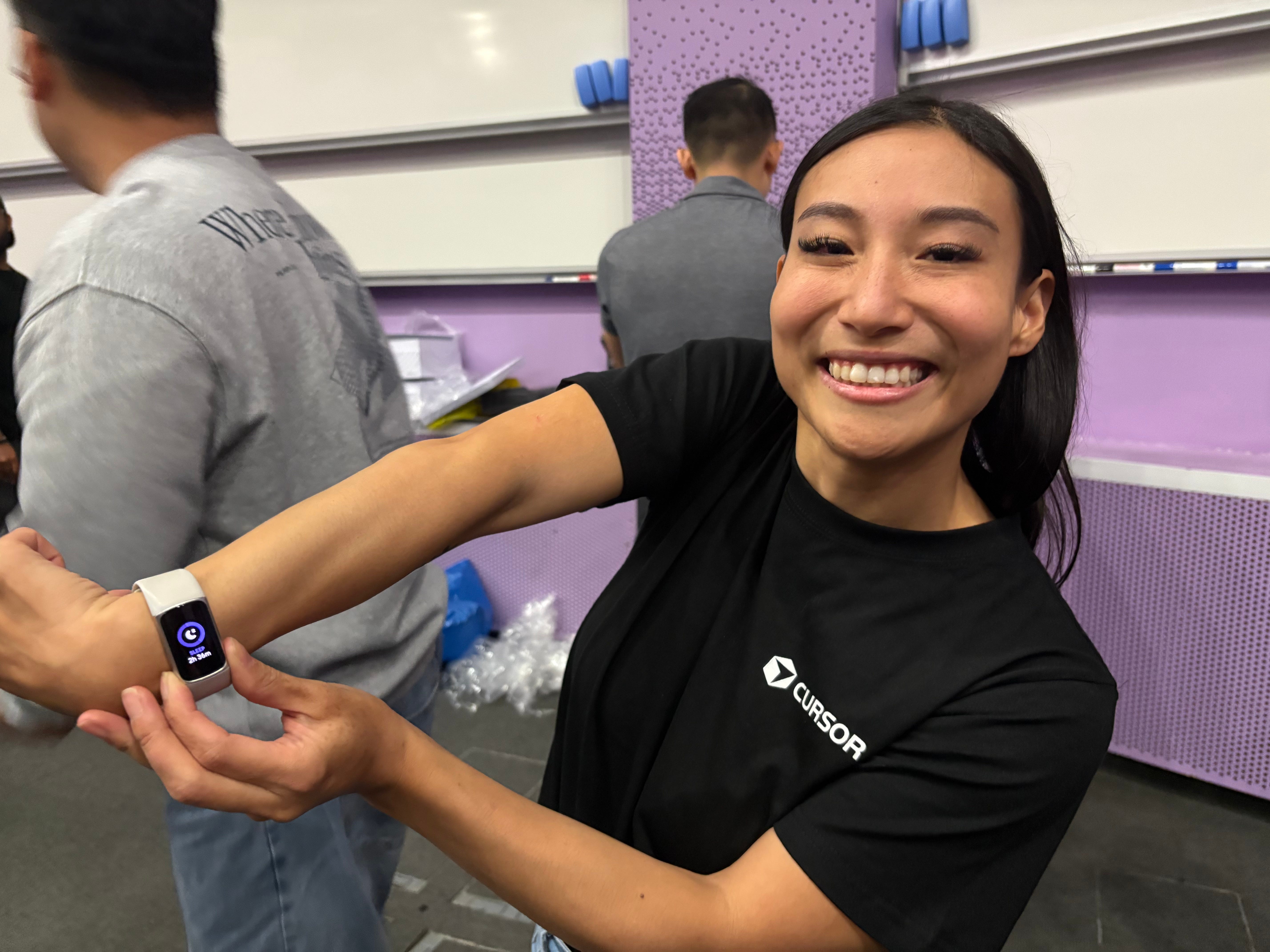 Sherry Jiang holding up her fitbit