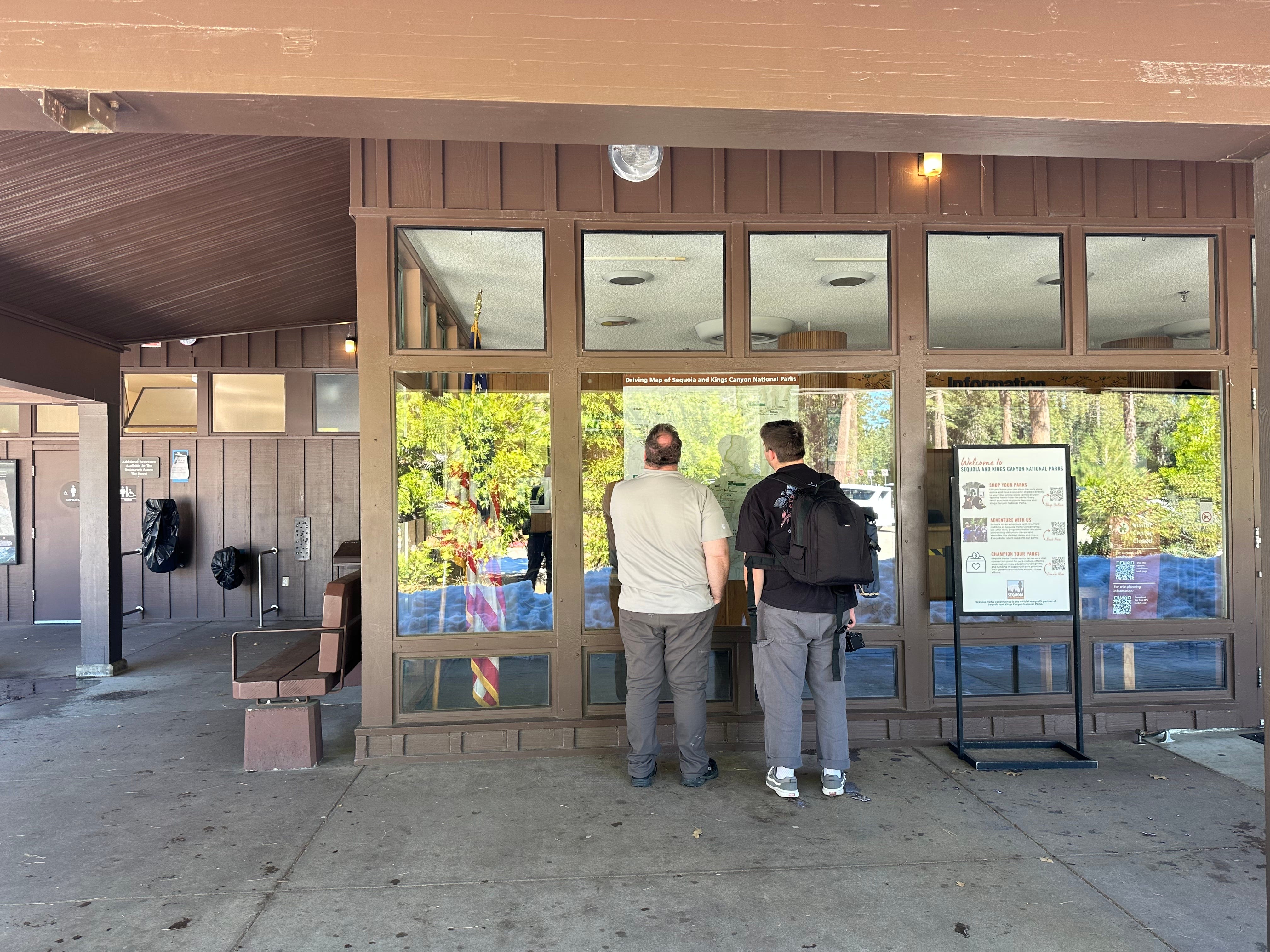 Visitors stand outside visitor center.