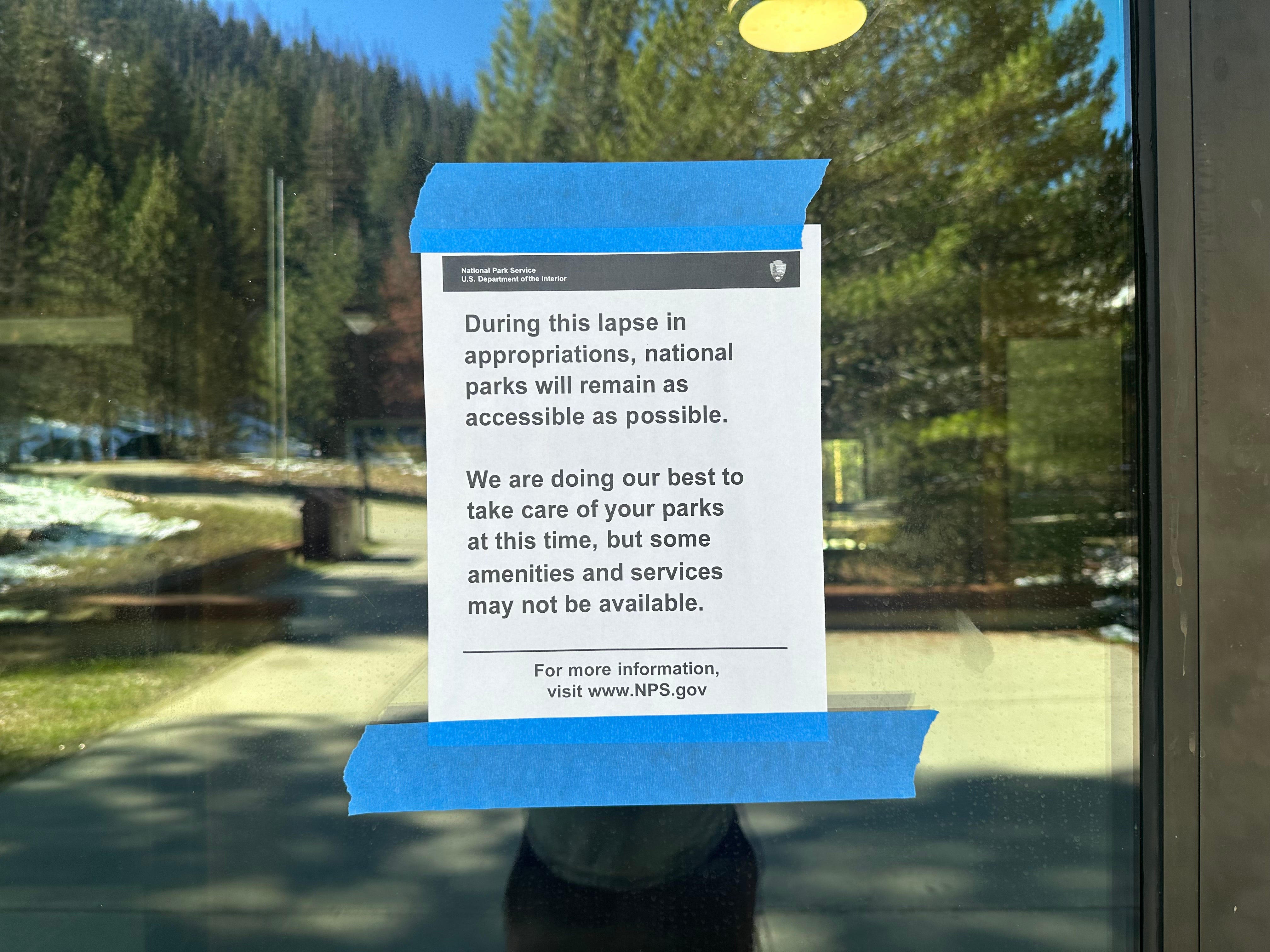 Sign posted on buildings about government shutdown.