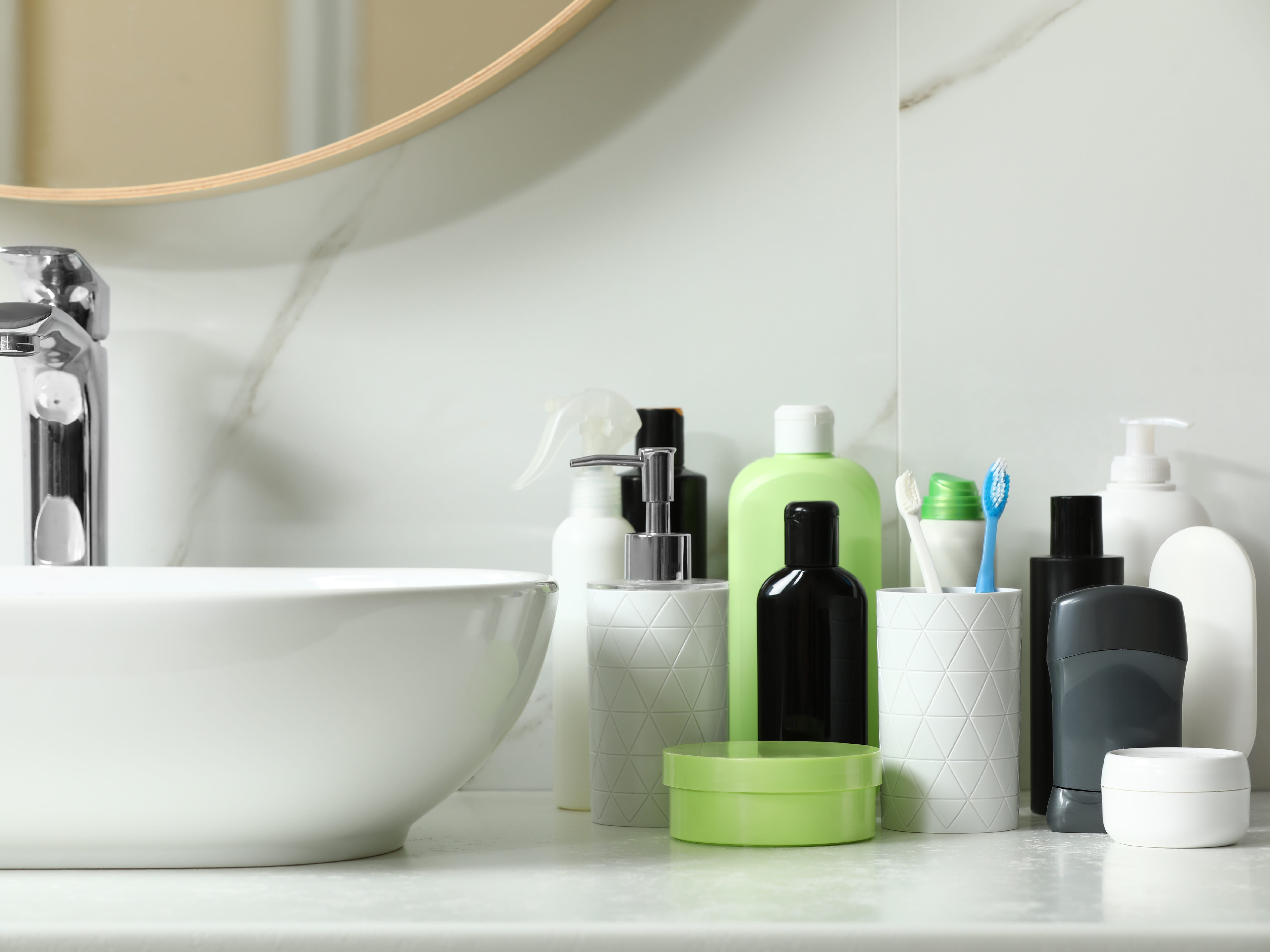 An arrangement of toiletries next to a bathroom sink.