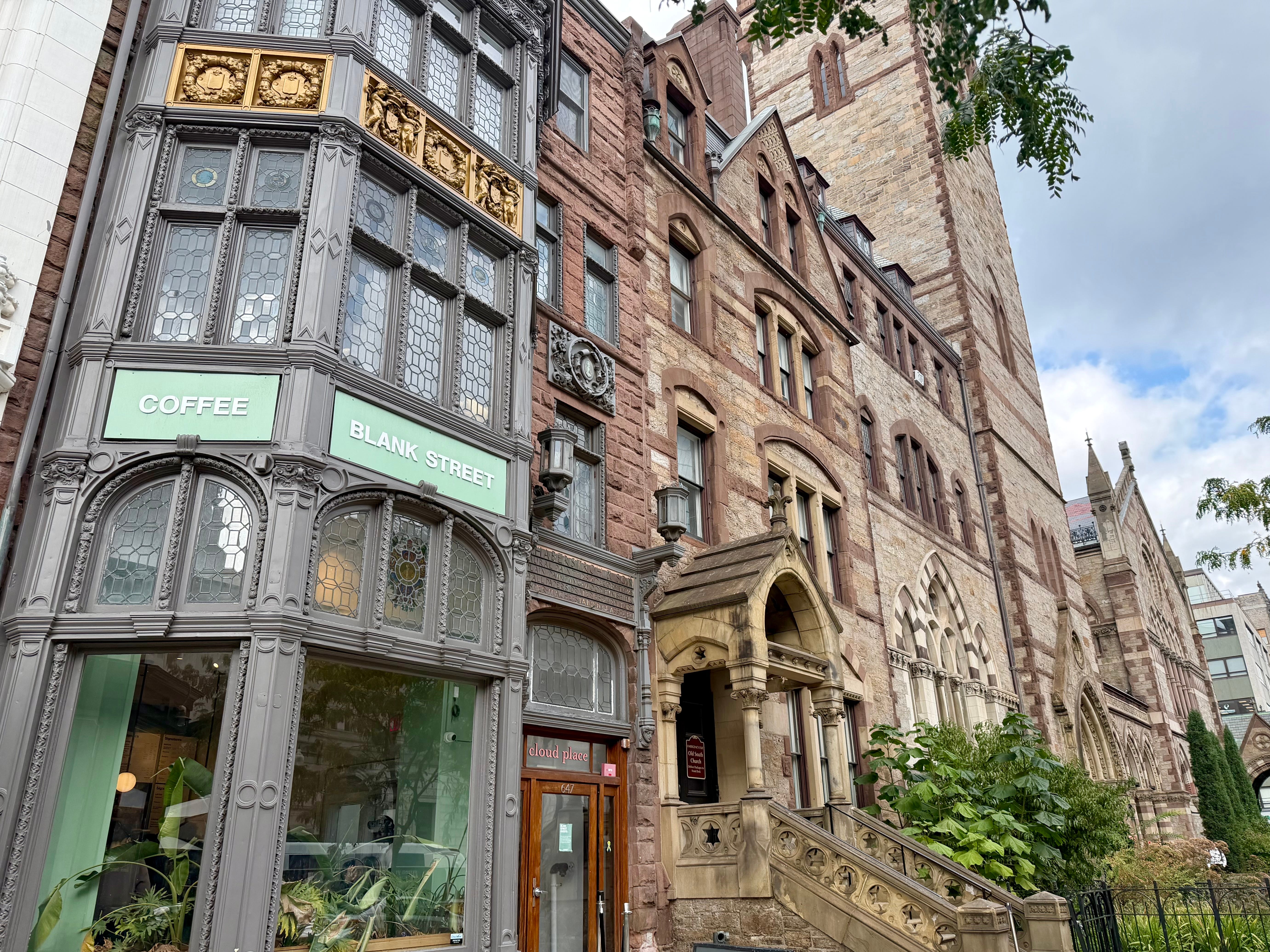 The exterior of Blank Street Coffee and other ornate buildings.