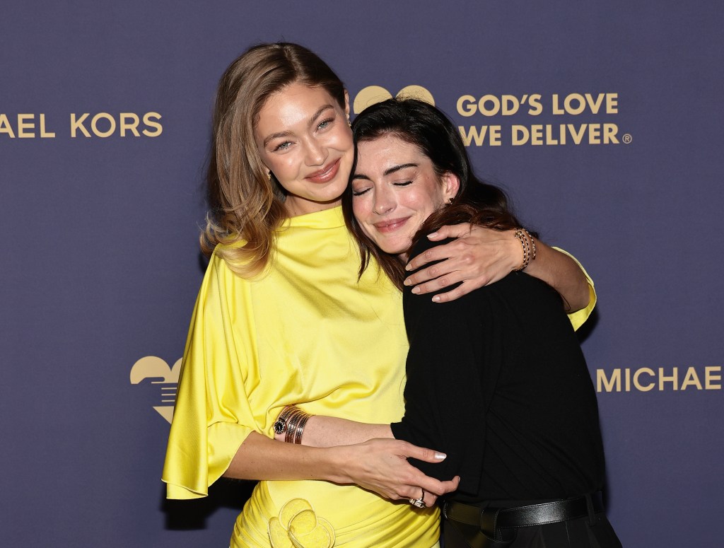 Gigi Hadid and Anne Hathaway embrace at the God's Love We Deliver 2025 Golden Heart Awards in NYC.